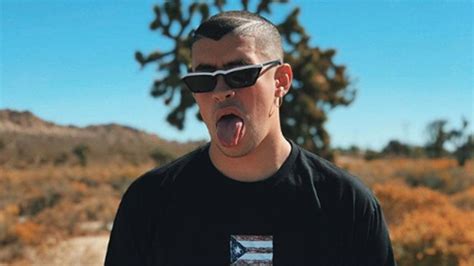 Bad Bunny Aesthetic Is Wearing Black Tshirt Standing In Blur Background With Tongue Out Hd Music