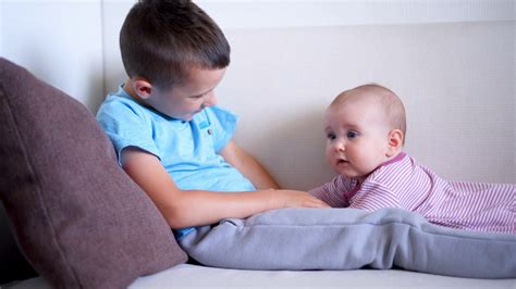 Smiling Brother Playing With His Little Sister On Sofa Stock Video Footage 00 23 Sbv 324240868