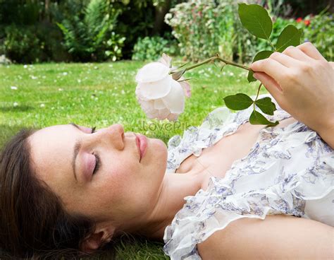 Woman Lying On The Grass And Smelling Roses Picture And Hd Photos
