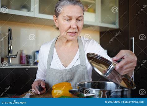 Mature Woman In Kitchen Preparing Food Stock Photo Image Of Kitchen
