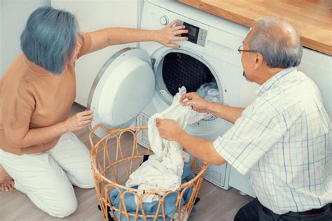 Contented Senior Couple Doing Laundry Together Stock Image Image Of