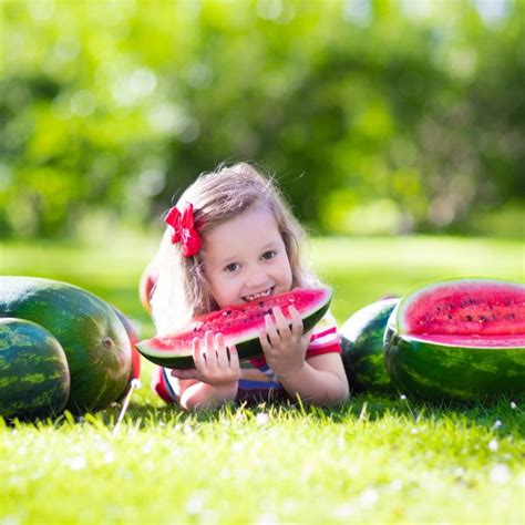 Little Girl Eating Watermelon In The Garden — Stock Photo © Famveldman