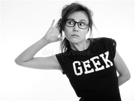 Studio Shot Of Young Asian Geek Girl Against White Background Stock