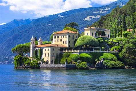 An Island In The Middle Of Water With Houses On It And Trees Growing