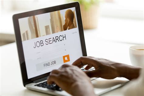 African American Man Browsing Work Online Using Job Search Computer App