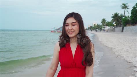 cheerful woman in red dress walking on sea beach stock footage video of lifestyle enjoy