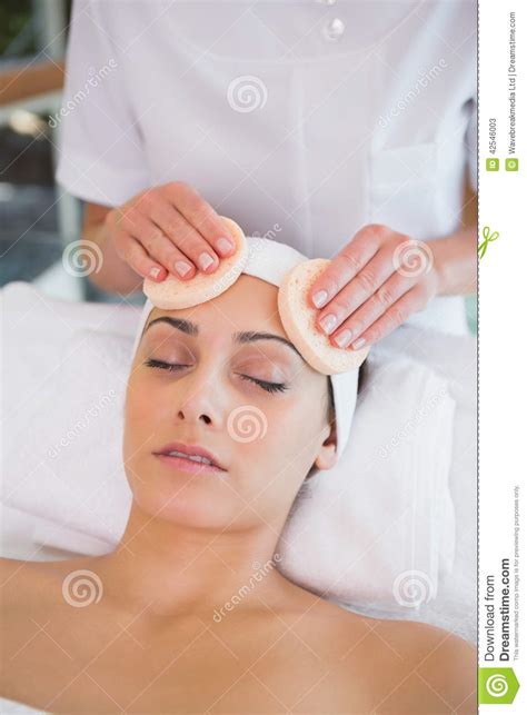 Peaceful Brunette Getting Facial From Beauty Therapist Stock Image