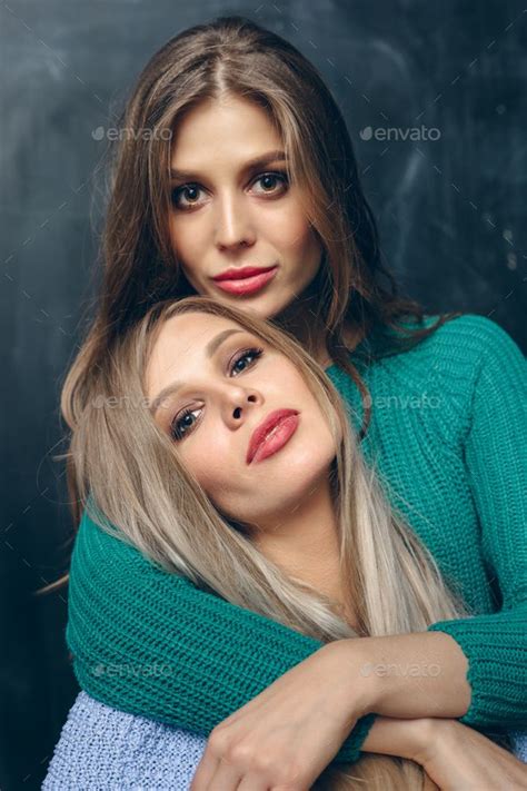 two pretty sisters hugging by johanjk on photodune portrait of two pretty sisters hugging