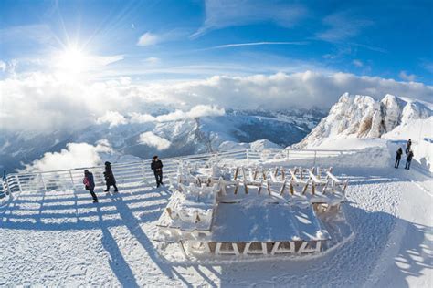 Sun And Clouds On The Snowy Peaks Of Dolomites Seen From The Terrace Of
