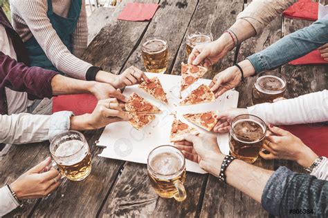 Happy Friends Eating Take Away Pizza And Drinking Beer Stock Photo