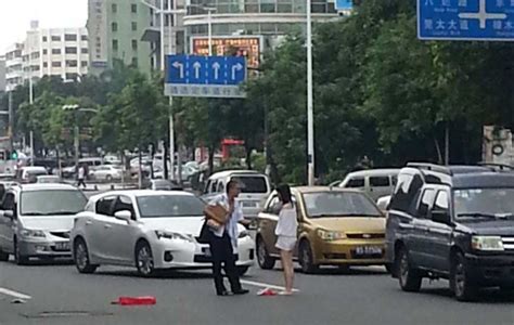 china fighting couple stops traffic with naked striptease in middle of road [photos]