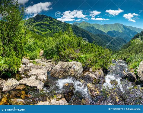 Amazing River Waterfall In The Heart Of The Mountains During A Sunny