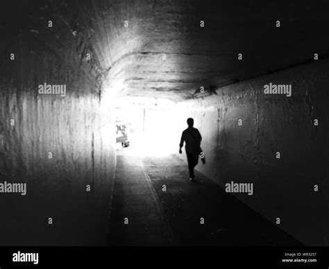 Silhouette Man Walking In Tunnel Stock Photo Alamy