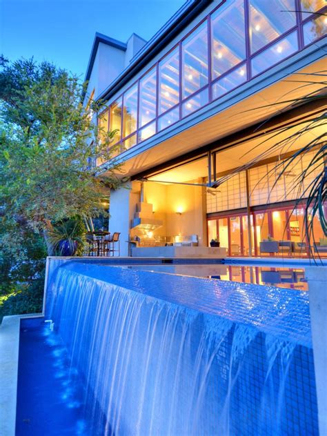 Contemporary Swimming Pool With Waterfall at Night | HGTV