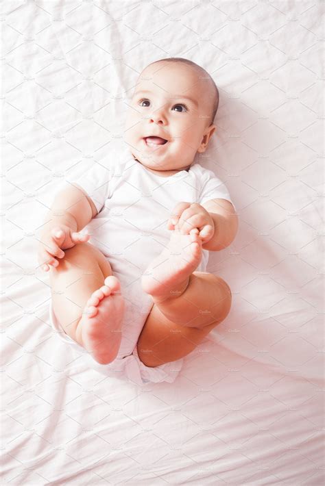 Portrait Of A Baby Lying On The Bed High Quality People Images