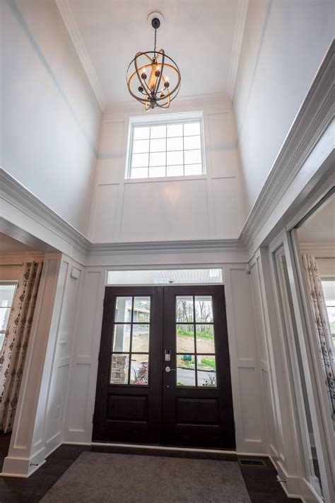 Window And A Orbital Light Fixture Brighten The 2 Story Foyer In An