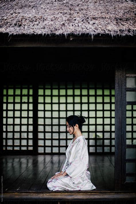 Beautiful Japanese Woman In Casual Silky Kimono Sitting In Traditional Japanese House Stock