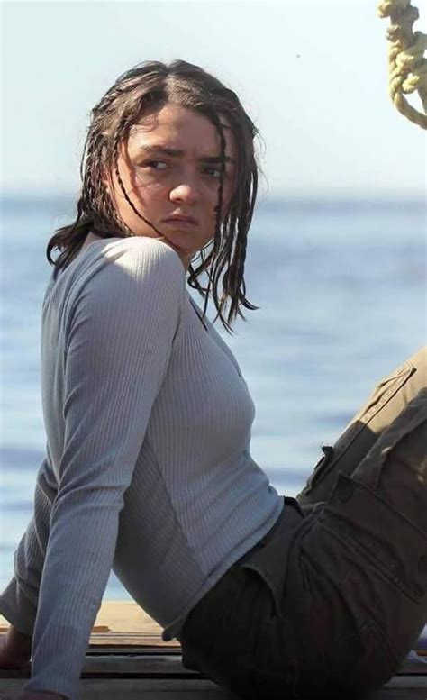 A Woman With Dreadlocks Sitting On A Dock