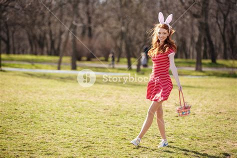 Full Length Portrait Of A Young Pretty Red Head Woman Walking In Park