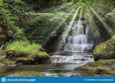 Majestic Waterfall In Forest Landscape Image With Added Drama Of Sun