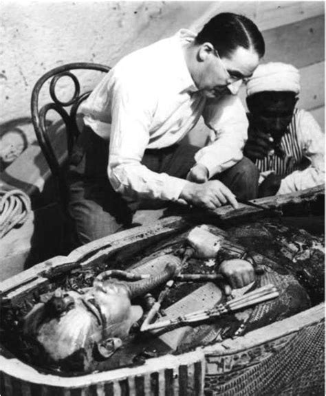 archaeologist howard carter examining the opened sarcophagus of king tut 1922 famous faces