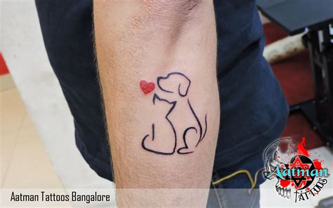 A Tattoo On The Arm Of A Man With A Dog And Heart