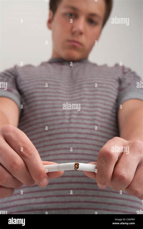 Teenage Boy Breaking Cigarette Studio Shot Stock Photo Alamy