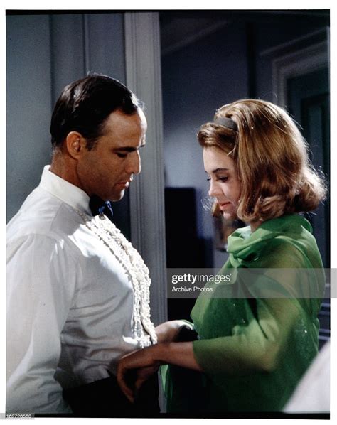 Angie Dickinson Adjusts Marlon Brando S Outfit In A Scene From The News Photo Getty Images