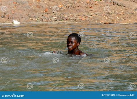 Unidentified Local Boy Swims In Water During A High Tide Editorial