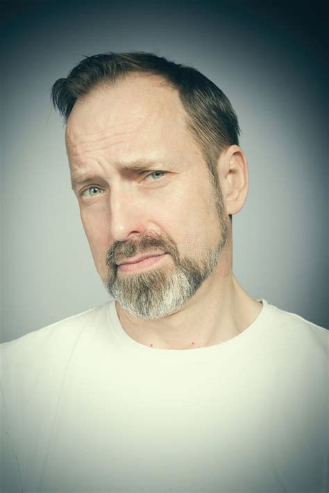 Portrait Of Man S Face In Studio When Trying Expressions Stock Photo
