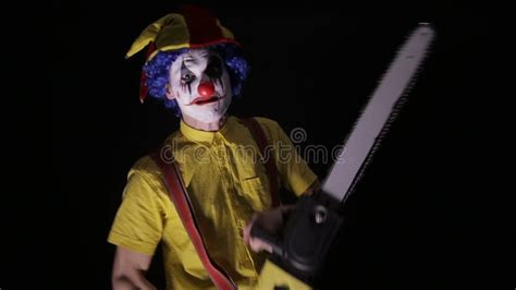 scary clown with a chainsaw in the dark clown murderer threatening you stock footage video of