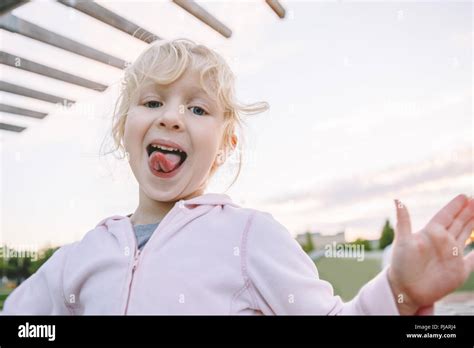 Baby Showing Tongue Portrait Of Cute Adorable Little Blonde Caucasian