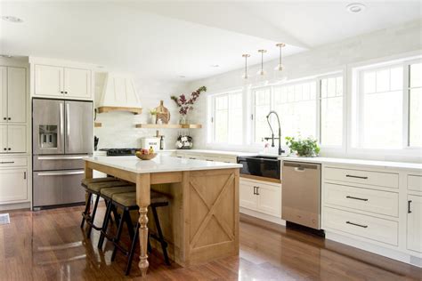 The use of polished nickel hardware and pendants adds a bright touch. Designing a Modern Farmhouse Kitchen with a Black ...