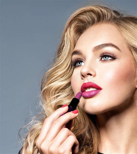 Beautiful Woman Colors Lips With Red Lipstick Makeup Stock Photo