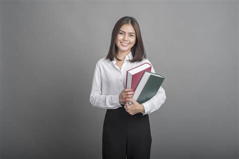 Beautiful Teacher Woman Holding Book On Grey Background 2597815 Stock
