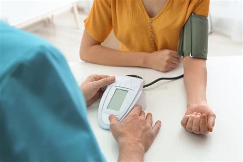 Doctor Checking Patient`s Blood Pressure In Hospital Closeup Stock