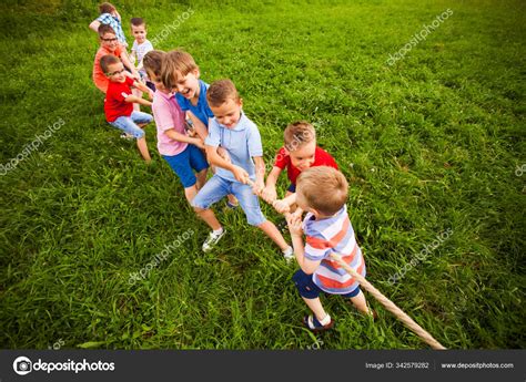 The Team Of Boys In A Game Of Tug Of War Stock Photo By ©oksixx 342579282