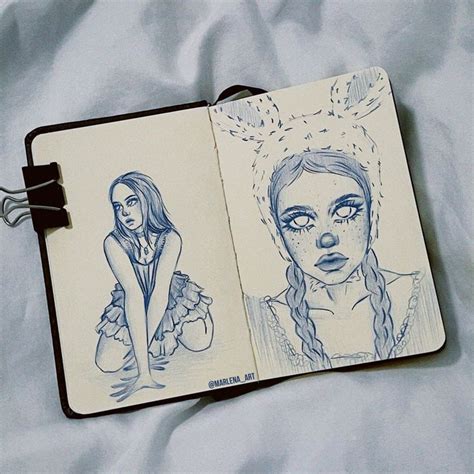 An Open Notebook With Two Drawings Of Women