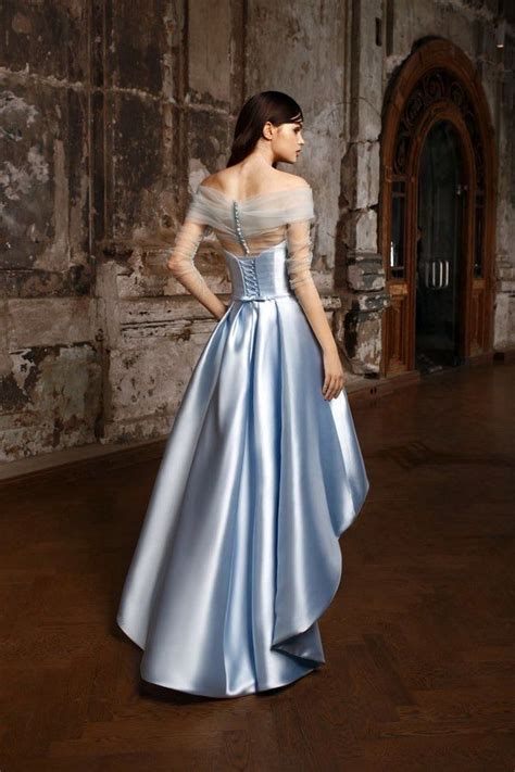 Bridesmaid tying buttons on wedding dress. blue satin wedding dress with buttons on the back #blue # ...