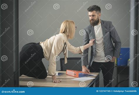 Boss Sexual Harassing To Blonde Secretary At Workplace Stock Photo