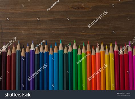 Colour Pencils On Wooden Texture Background Stock Photo 551374597