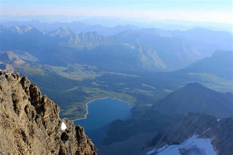 Looking Down At Lake Magog From The Summit Of Mount Assiniboine Altus