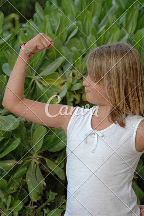 Young Girl Showing Arm Muscles Photos By Canva