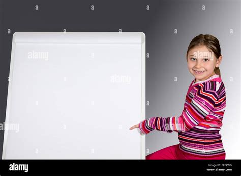 Young Girl Pointing At Blank Presentation Stand Smiling And Looking At