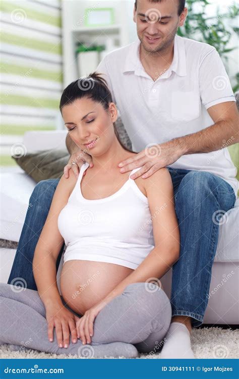 pregnant woman receiving shoulder massage from her husband stock image image of male