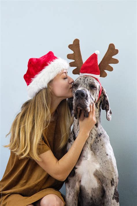 Girl Kissing Dog In Hat By Stocksy Contributor Danil Nevsky Stocksy