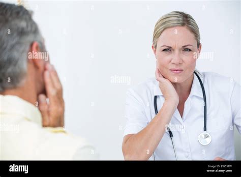 Doctor Examining Patient With Neck Ache Stock Photo Alamy