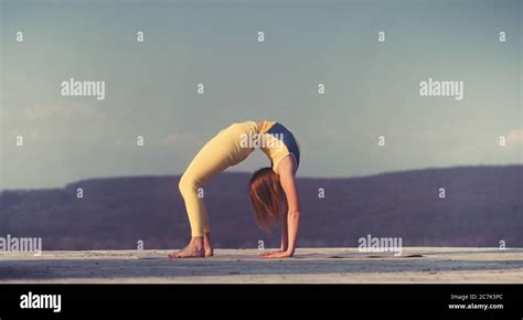 Young Gymnast Girl Perform Various Gymnastic And Yoga Exercises Including Splits And Bending