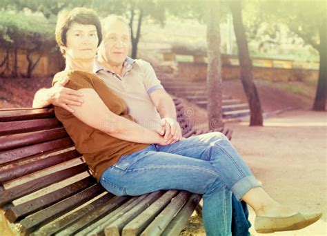Mature Man With A Woman Sitting On Bench Stock Photo Image Of Beauty