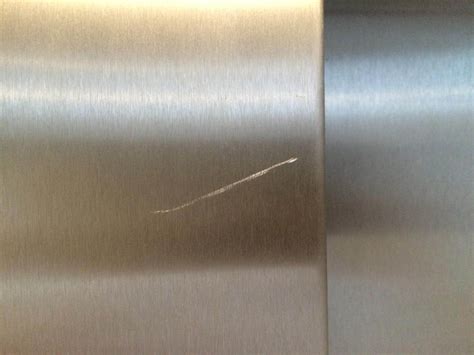 Small scratches on stainless steel can happen with regular use. Stainless steel lift door scratch removal | Bespoke Repairs